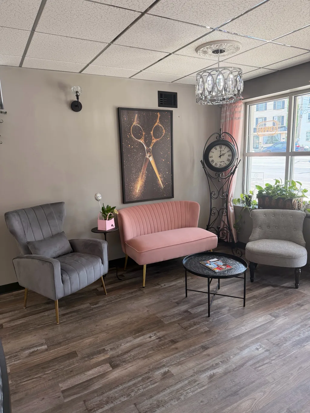 Waiting lounge with a blush velvet sofa and chandelier